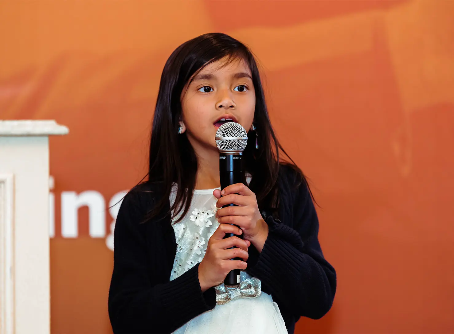 girl speaking in to microphone
