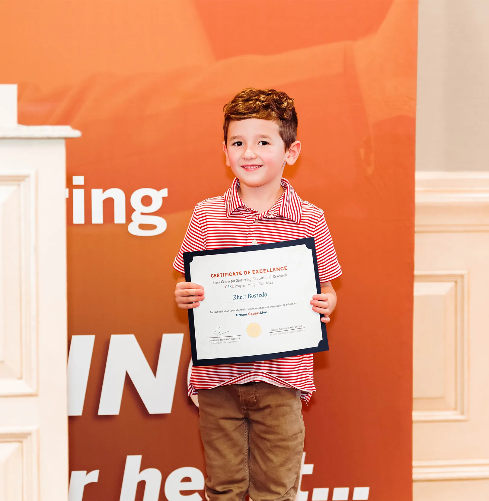 Smiling boy holding certifiate