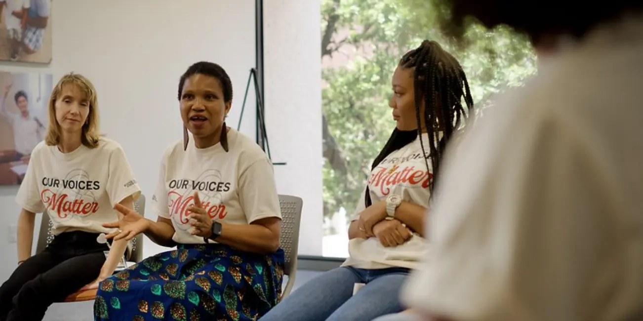 Ladies sit in conversation discussing their experiences as people who stutter