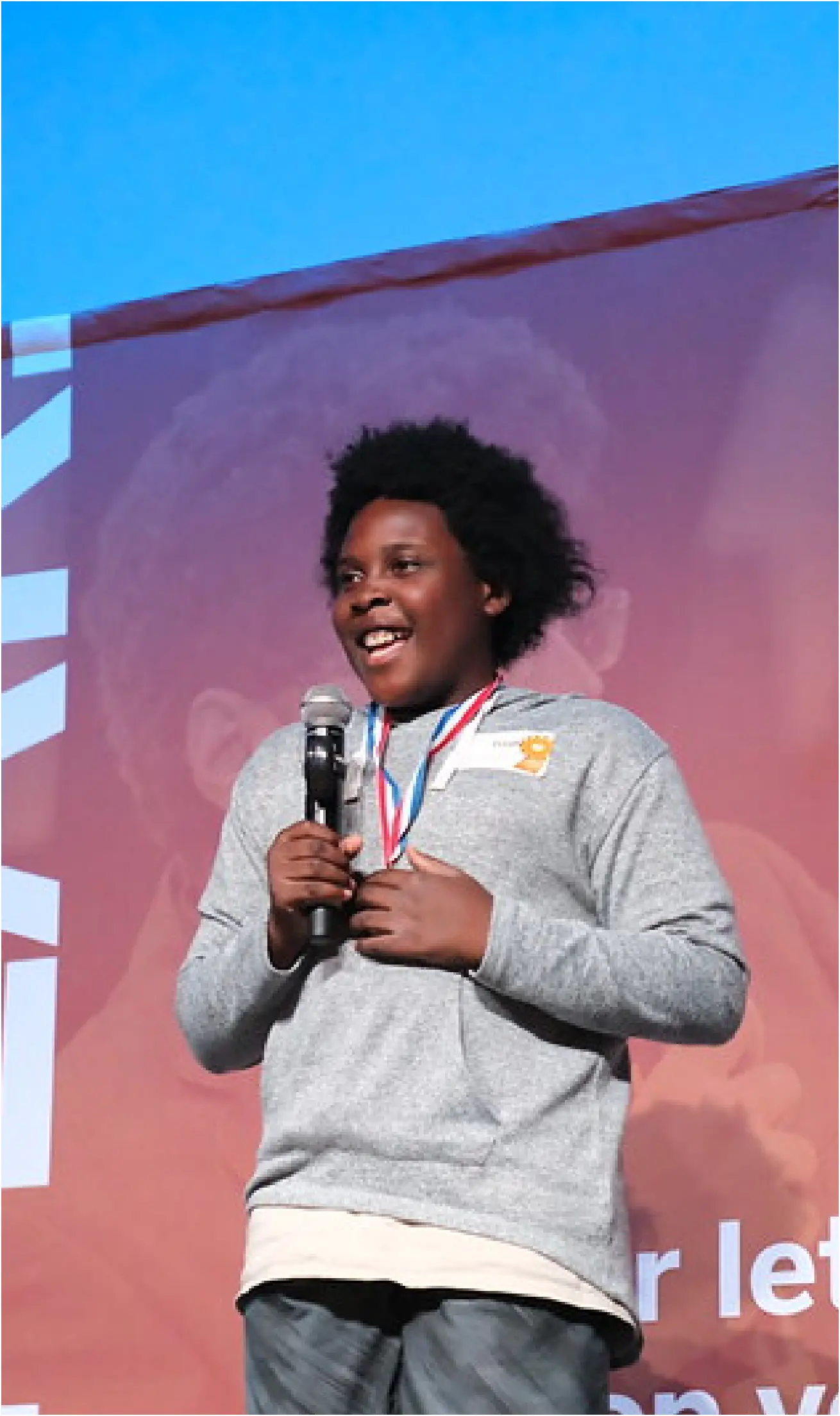 boy speaking into microphone